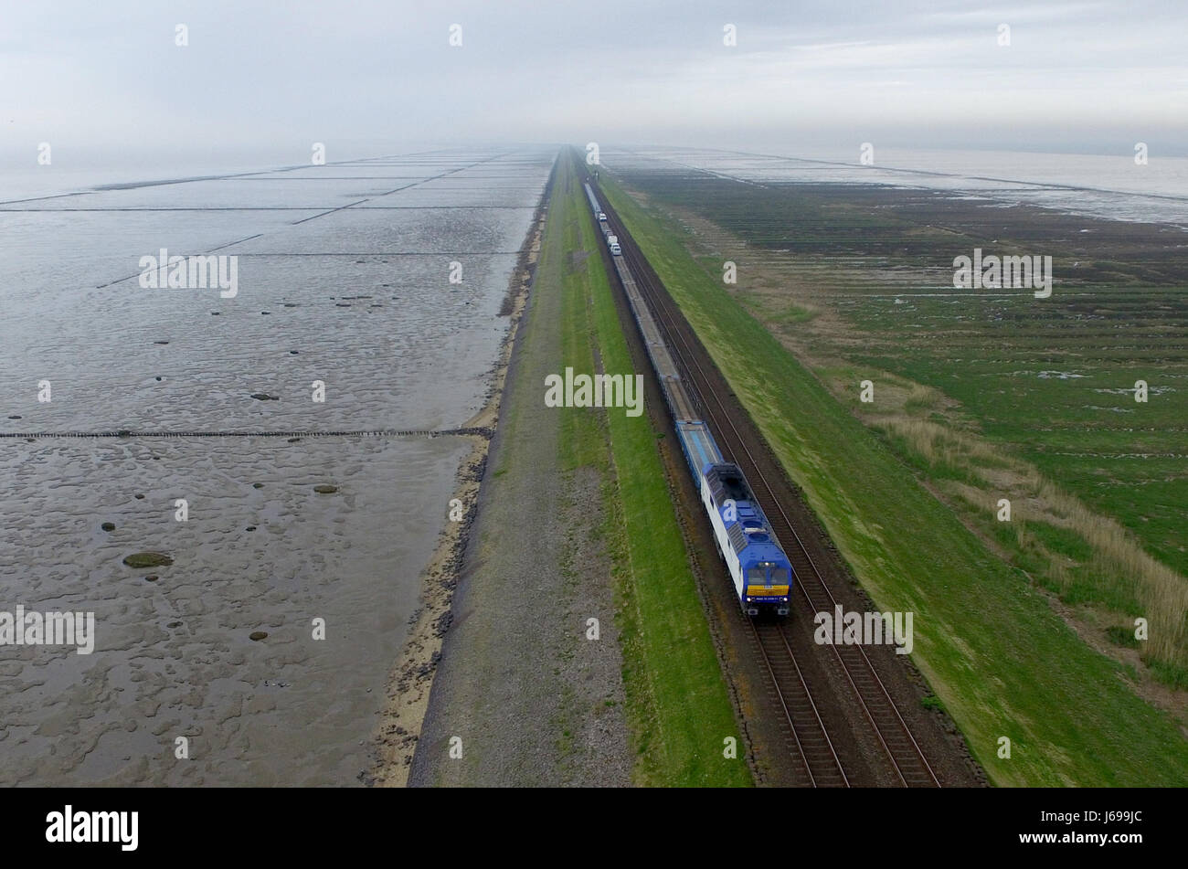 A car train of the Railroad Development Corporation (RDC) makes its way along the Hindenburg Dam between Sylt and Niebuell, Germany, 17 May 2017. Photo: Carsten Rehder/dpa Stock Photo