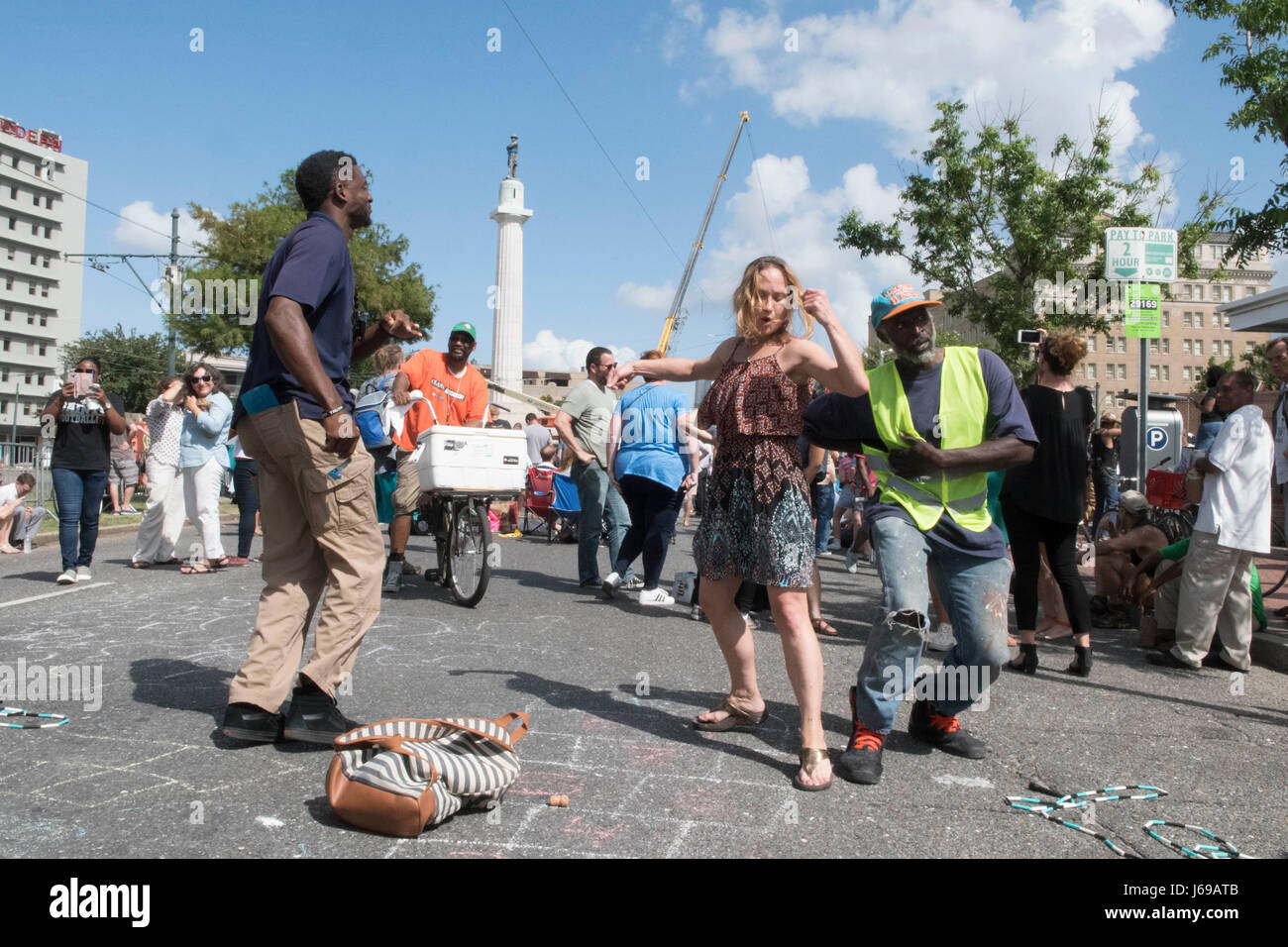 New Orleans, Louisiana USA May 19, 2017:  People party in the street as workers prepare to remove the 16-foot tall statue of Confederate General Robert E. Lee, the fourth monument commemorating the Confederacy in the city to be removed on orders of Mayor Mitch Landrieu. Credit: Bob Daemmrich/Alamy Live News Stock Photo