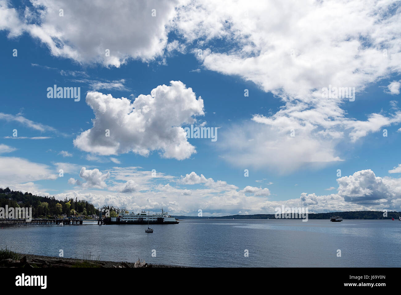 Summer sky over Puget sound with Ferry boat and billowing clouds Stock Photo