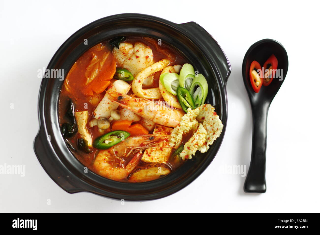 Seafood soup with rice cake and tofu, shrimp, octopus, mushroom and carrot Stock Photo