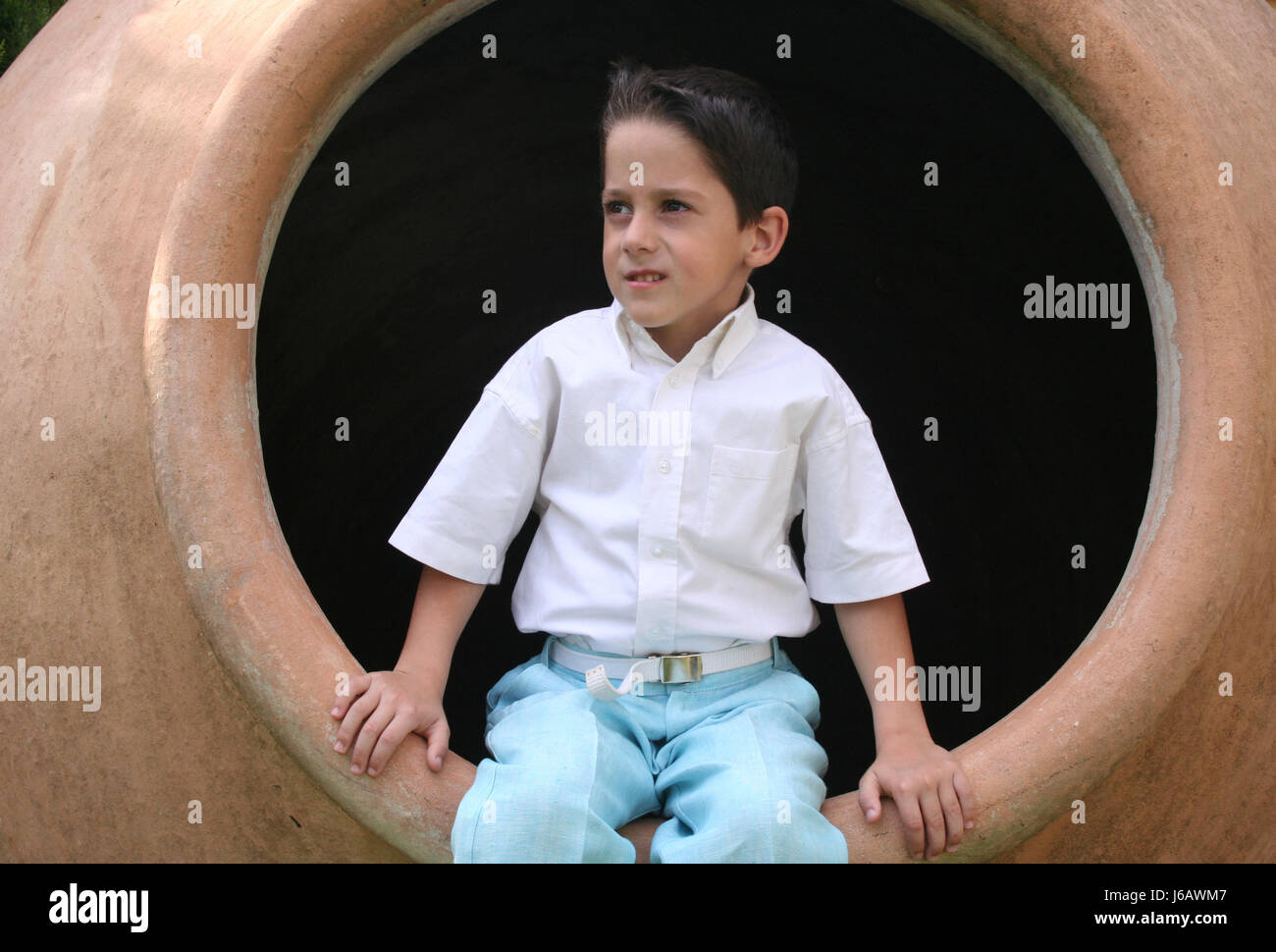 boy in ceramic barrel Stock Photo