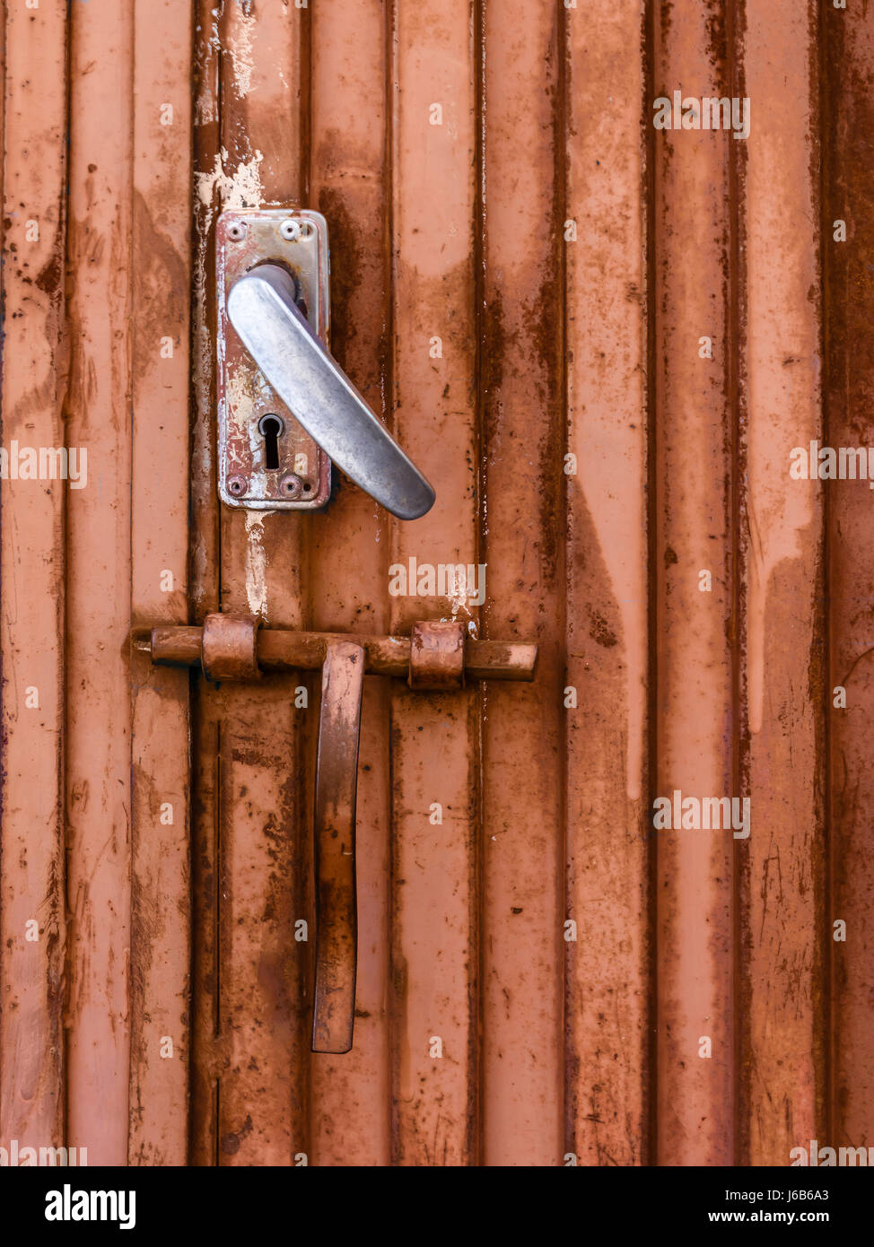 Old rusty iron door closed with lock Stock Photo Alamy