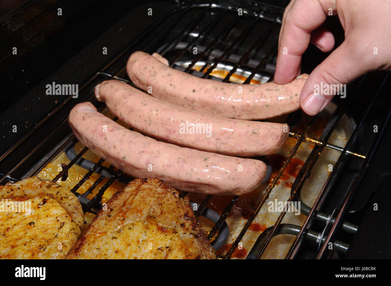 hand garden energy power electricity electric power sausage grill barbecue Stock Photo