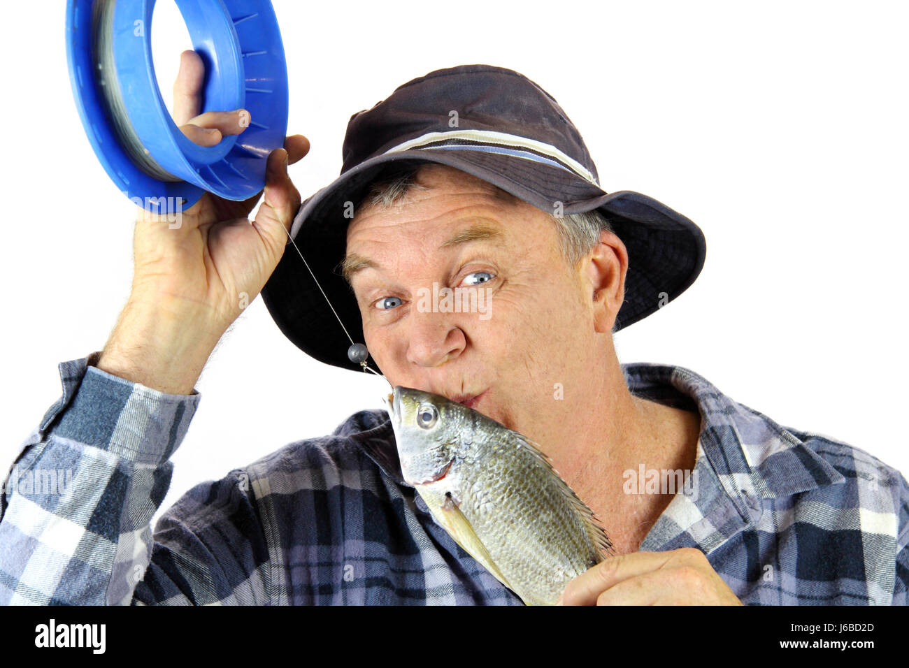 Old fisherman with pole Wearing a hat full of Tackle looking very silly  Stock Photo - Alamy