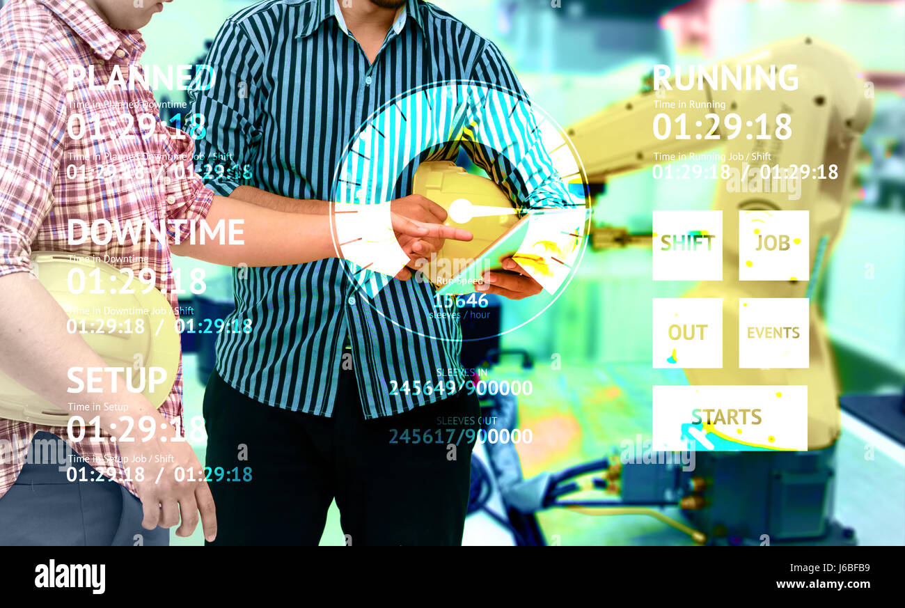 Industry 4.0 internet of things concept. Application UI screen graphic and two Engineers finger point to tablet for monitoring blur automation wireles Stock Photo