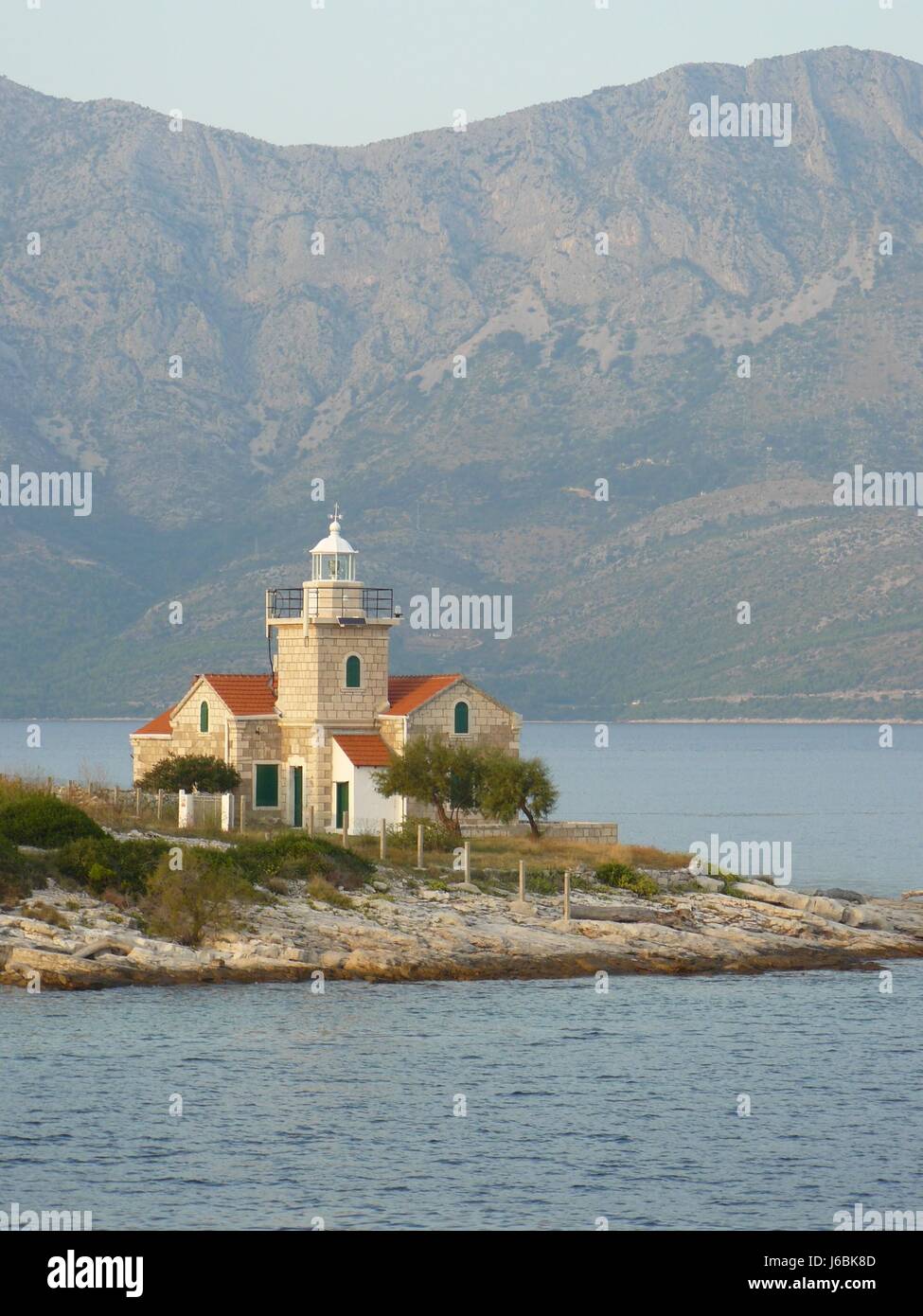 croatia salt water sea ocean water mountain lighthouse isle island peaceful Stock Photo
