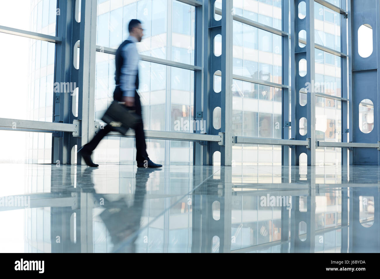 Blurred figure of businessmen walking to work Stock Photo - Alamy