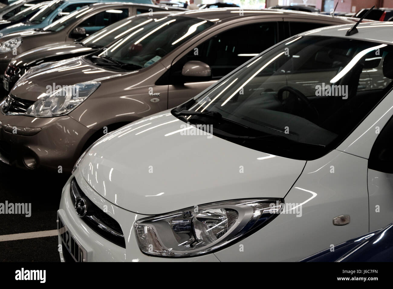 A row of cars parked at the indoor covered Tesco and M&S parking in