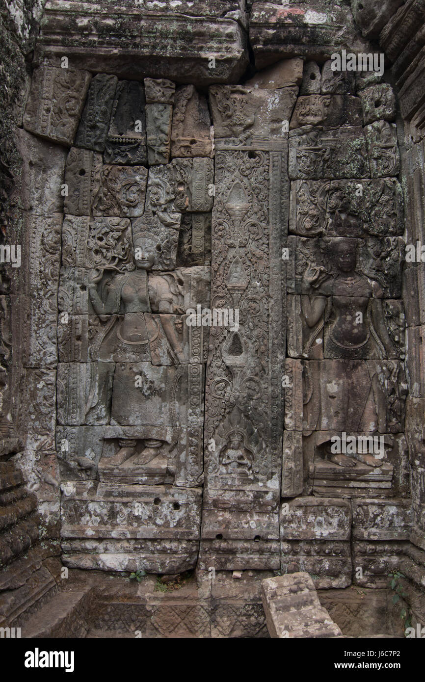 Stone bass reliefs of two apsaras in the Bayon temple in the Angkor Wat complex Stock Photo