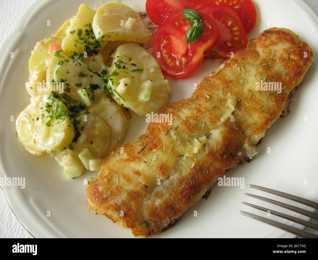 fish fillet with potato salad Stock Photo