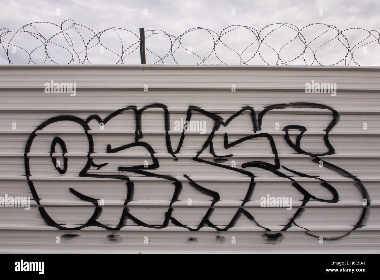 Tags and barbed wire on a palisade Stock Photo - Alamy