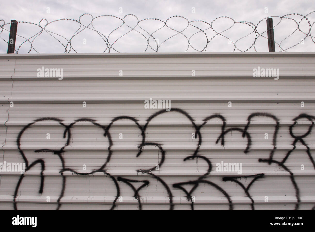 Tags and barbed wire on a palisade Stock Photo - Alamy