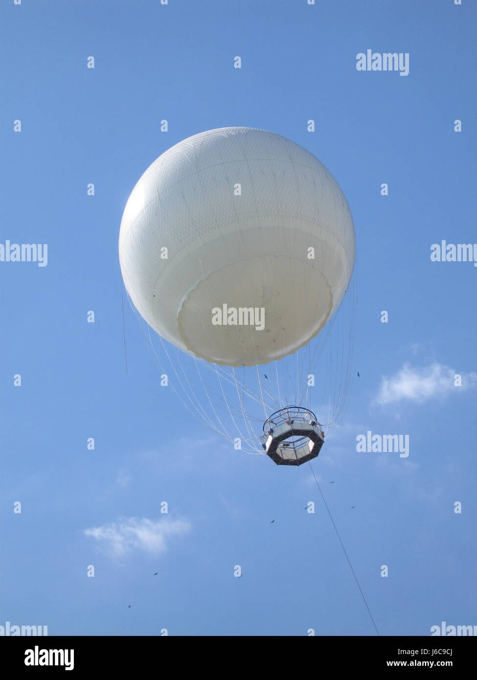 Weather balloon on a blue sky Stock Photo