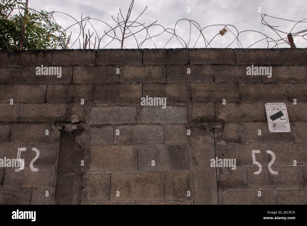 Tags and barbed wire on a wall Stock Photo - Alamy