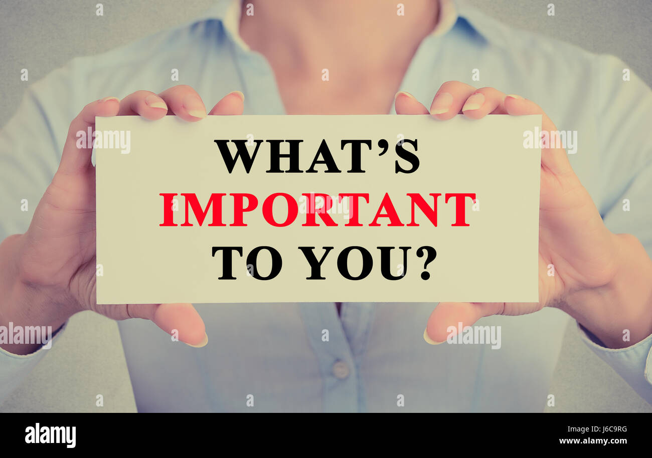 Businesswoman hands holding white card sign with What is important to ...