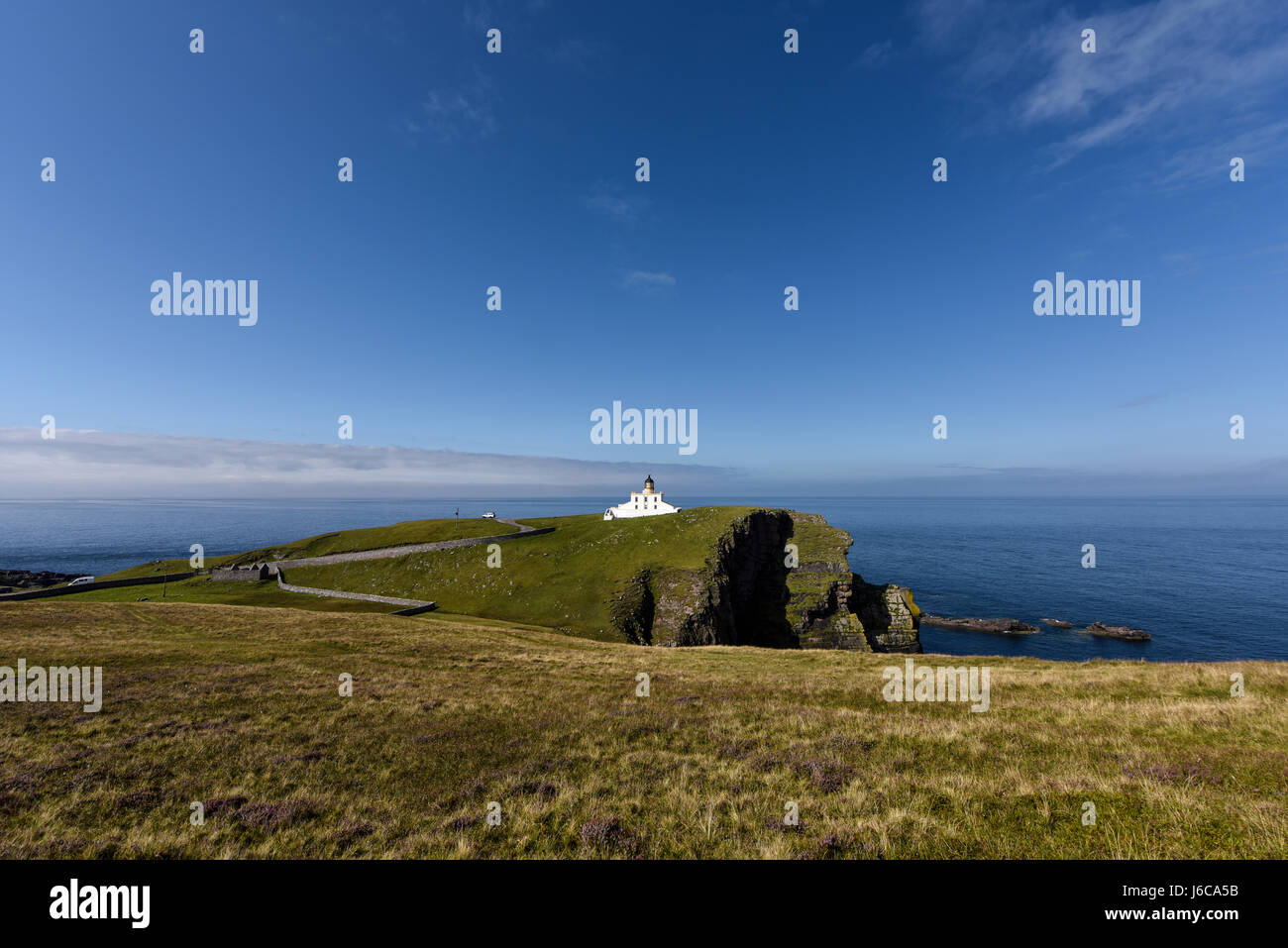Lighthouse Point of Stoer on a sunny day with gorgeous blue sky. Assynt, Highlands, Scotland, United Kingdom Stock Photo