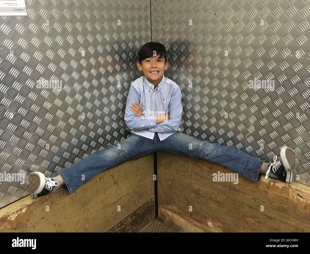 Young Boy doing the slip in a lift elevator Stock Photo - Alamy