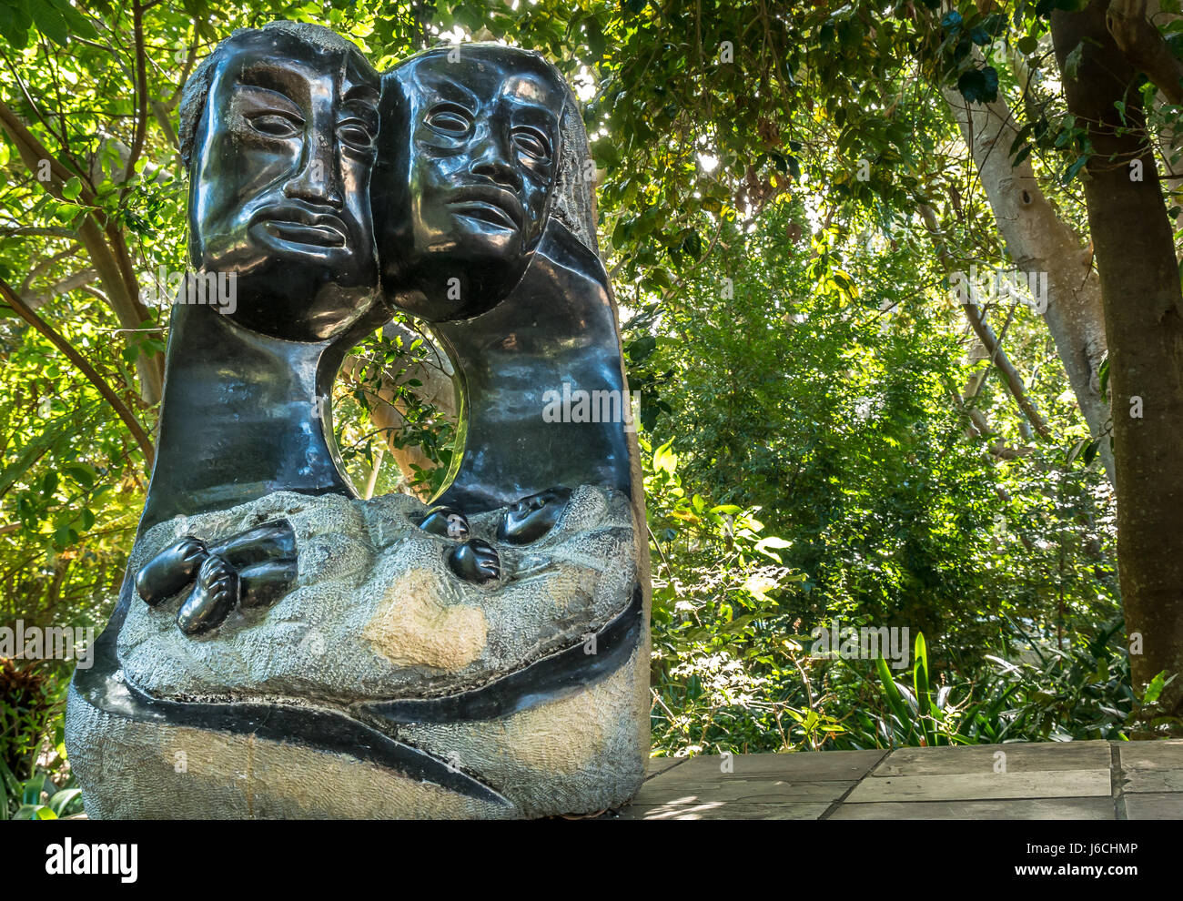 Zimbabwean Mambo stone sculpture depicting parents holding newborn baby, Kirstenbosch National Botanical Garden, Cape Town, Western Cape, South Africa Stock Photo