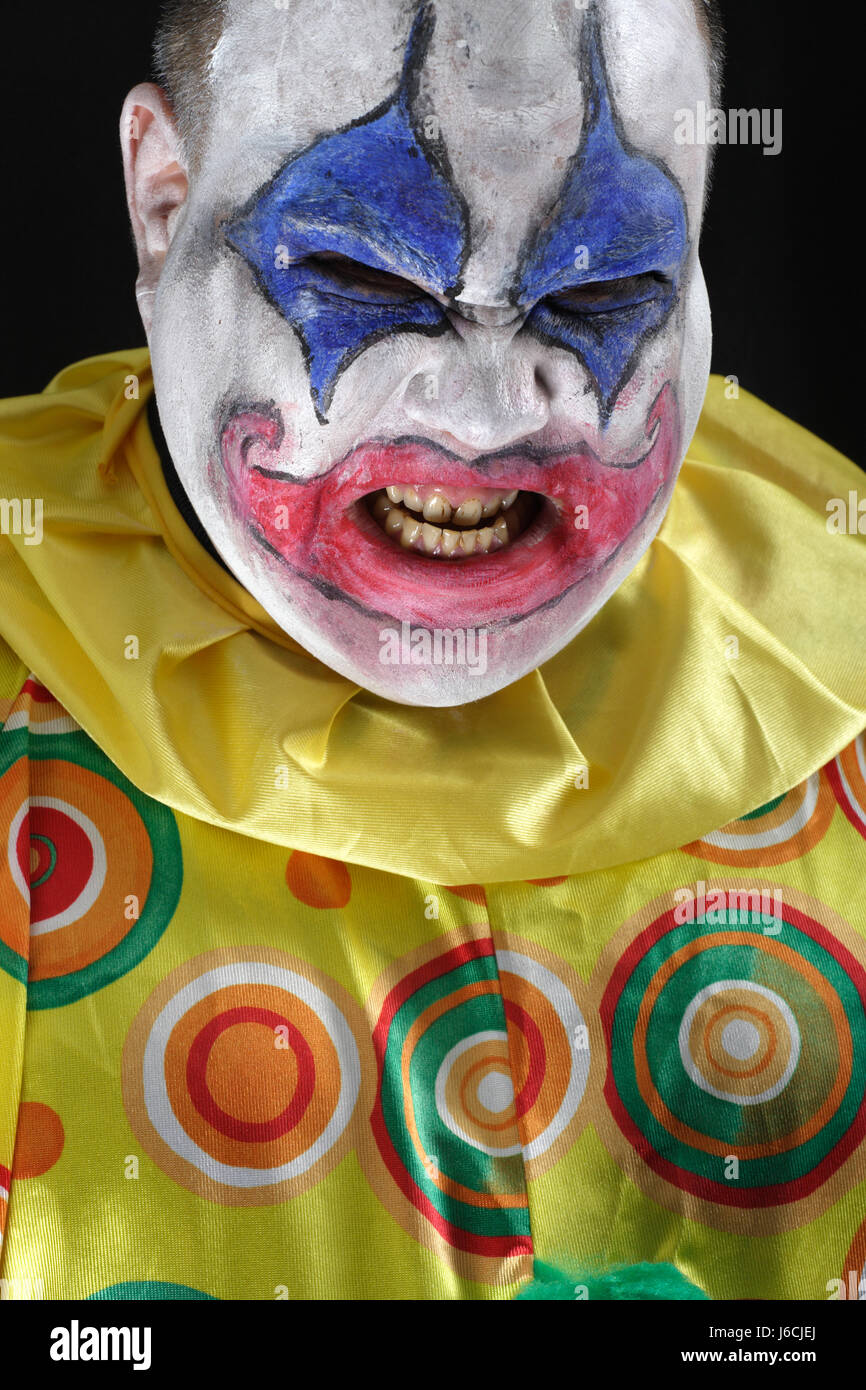male masculine face clown scary bad peccant wickedly evil halloween costume Stock Photo