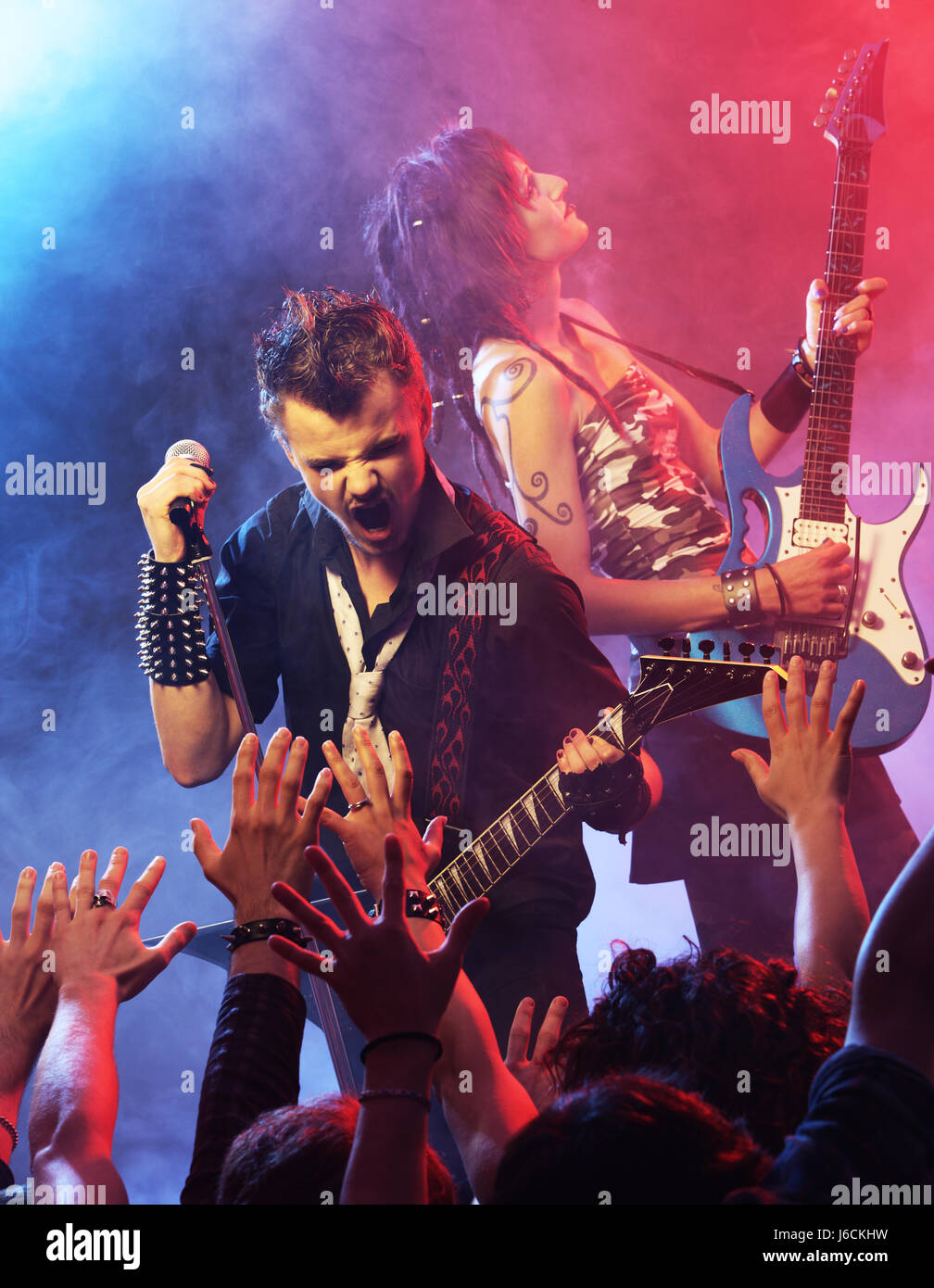 Rock band performing on stage Stock Photo Alamy