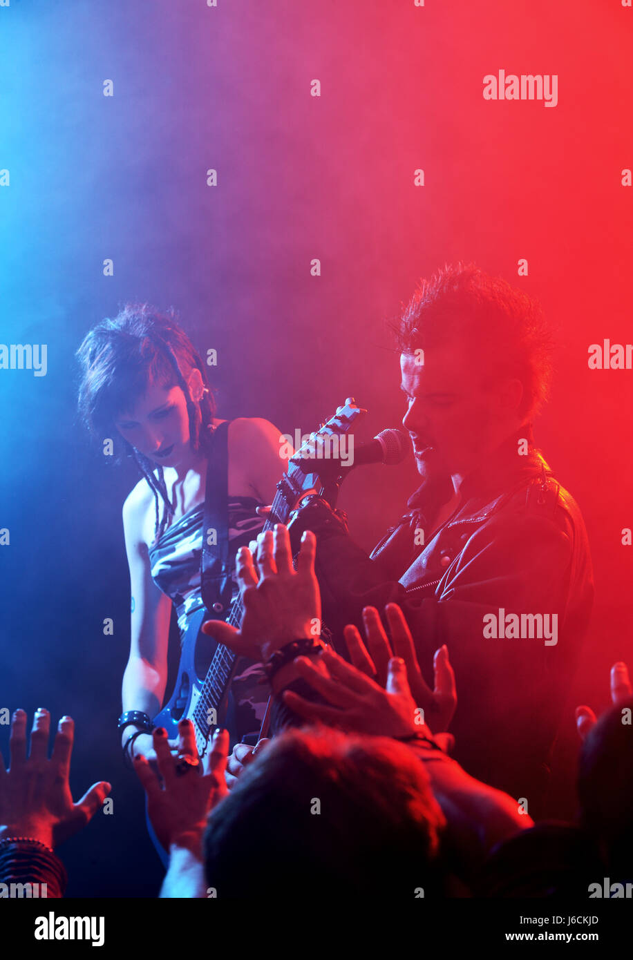 Rock band live. Rockstar singer on stage Stock Photo - Alamy