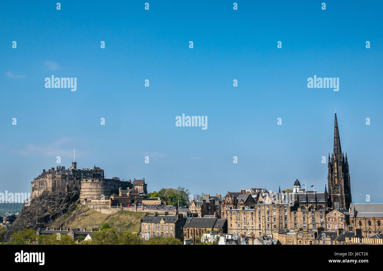Old Town and Royal Mile skyline, Edinburgh, Scotland, UK, with Edinburgh Castle rock and The Hub spire against bright blue sky Stock Photo
