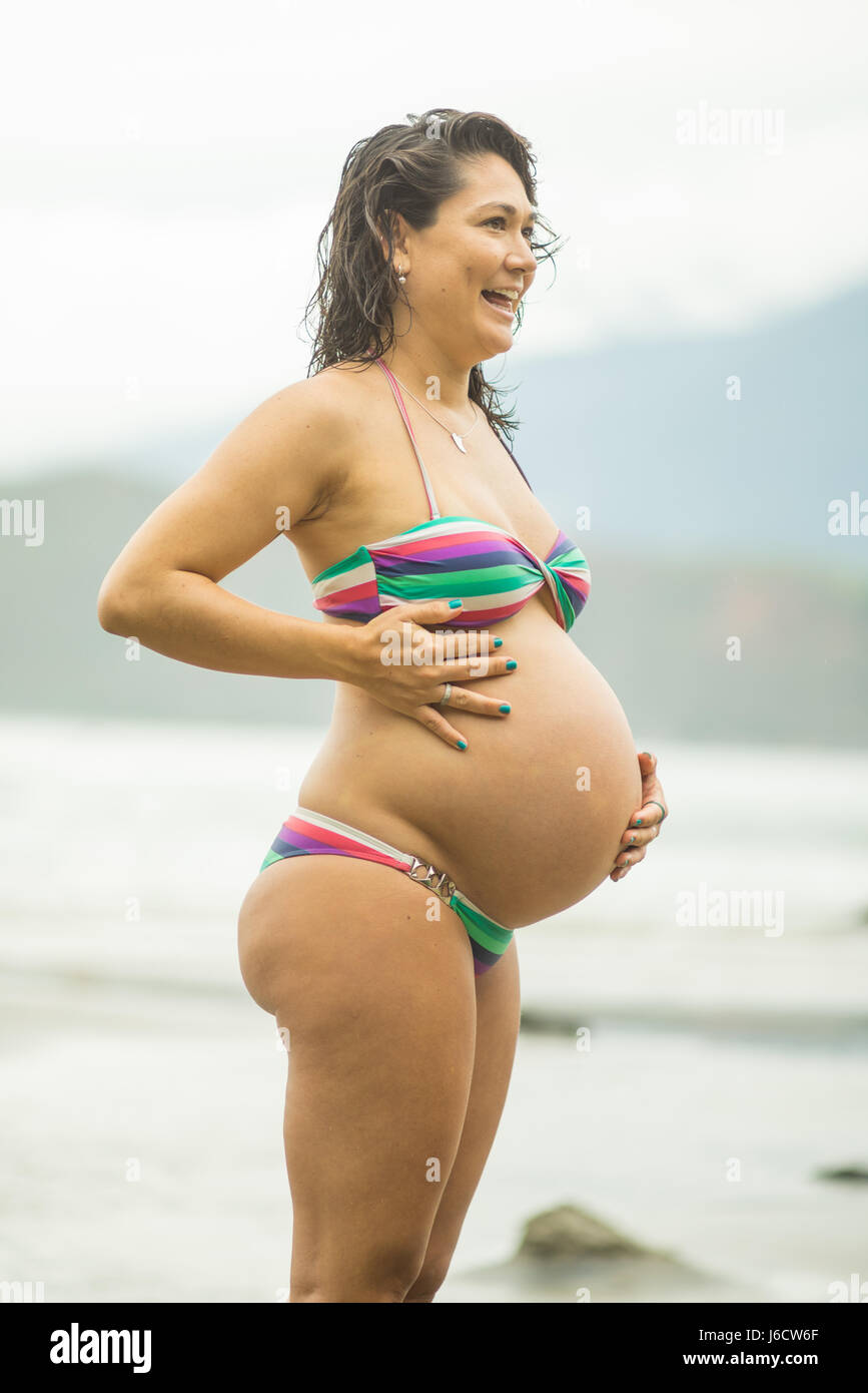 35 years old mixed race brazilian hawaiian looking pregnant in bikini at  the beach. 8 months Stock Photo - Alamy