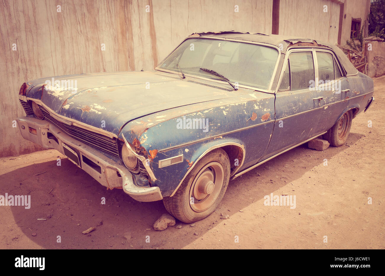 Old vintage rusty car abandoned in a desert town Stock Photo - Alamy