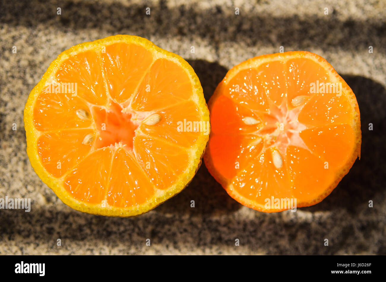 Lemon: Rangpur lime sliced on half with some apparent seeds Stock Photo
