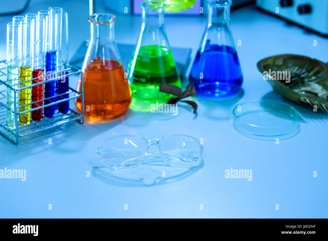 Glasses and scientific experiments in laboratory Stock Photo