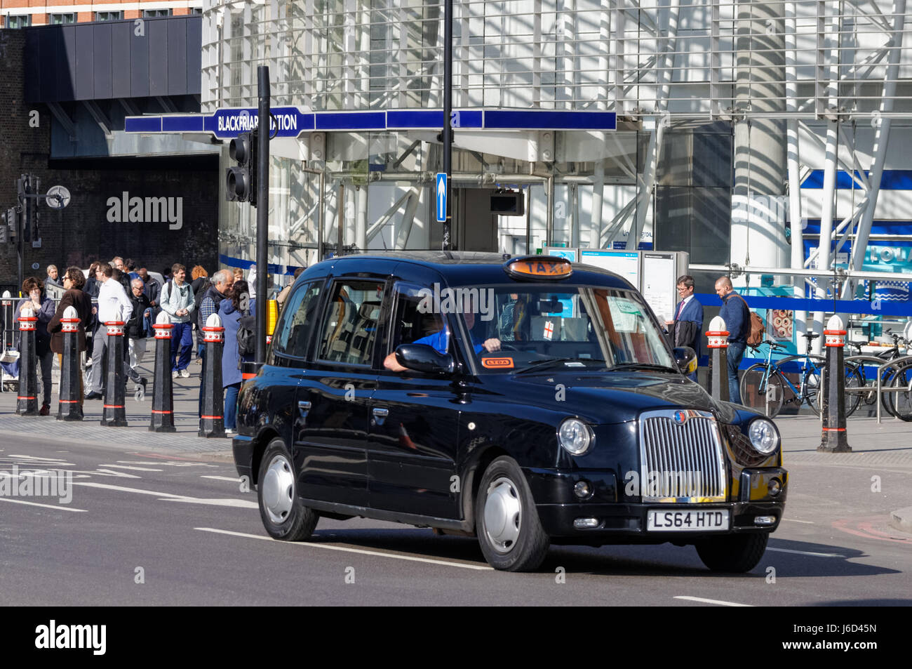 Black taxi cab in front of Blackfriars tube station, London England United Kingdom UK Stock Photo