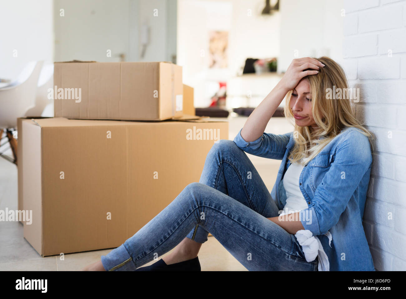 Tired woman exhausted while moving into new home Stock Photo