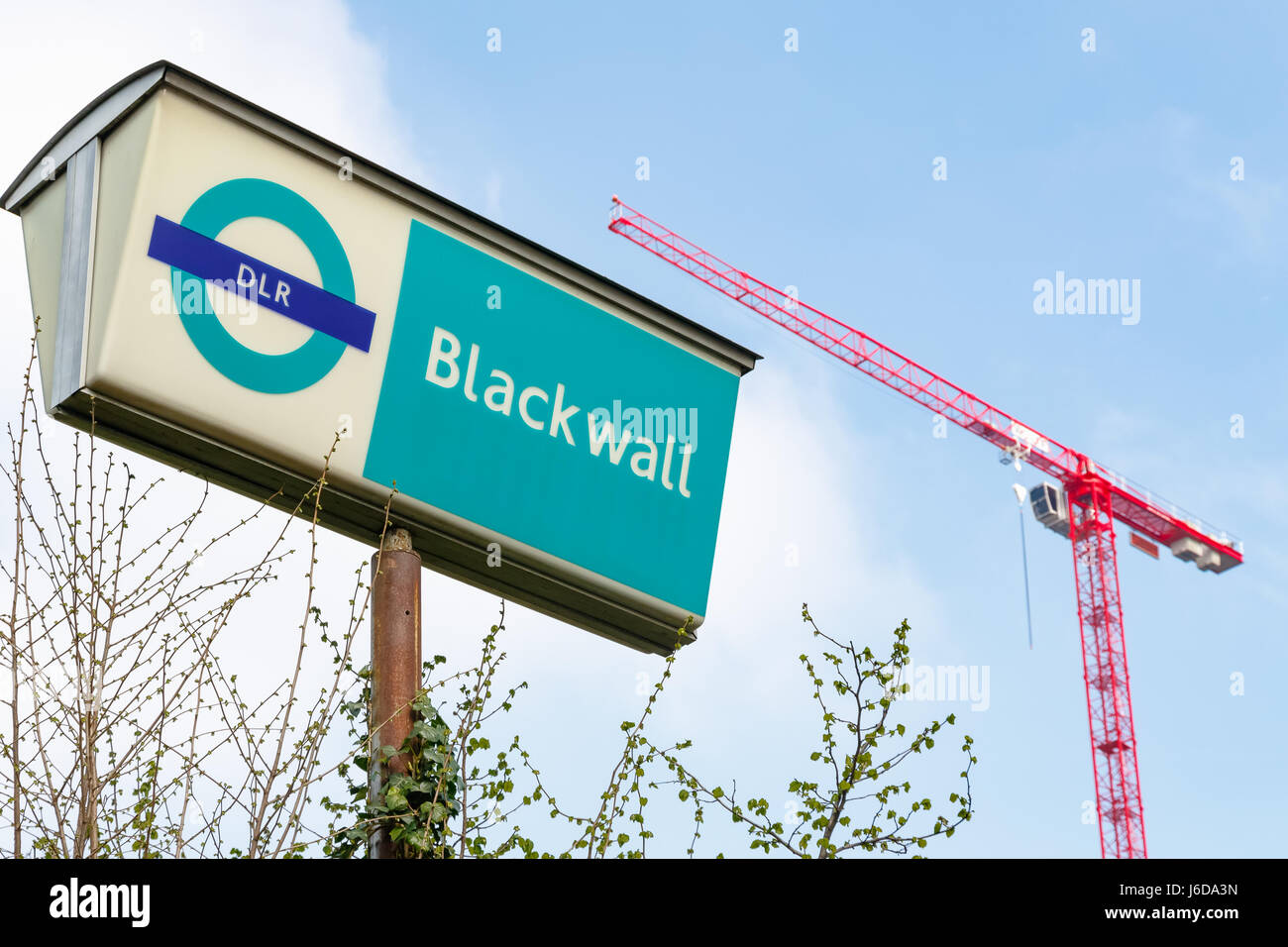 London, UK - March 27, 2017 - Blackwall Docklands Light Railway station sign with a red building crane in the background Stock Photo