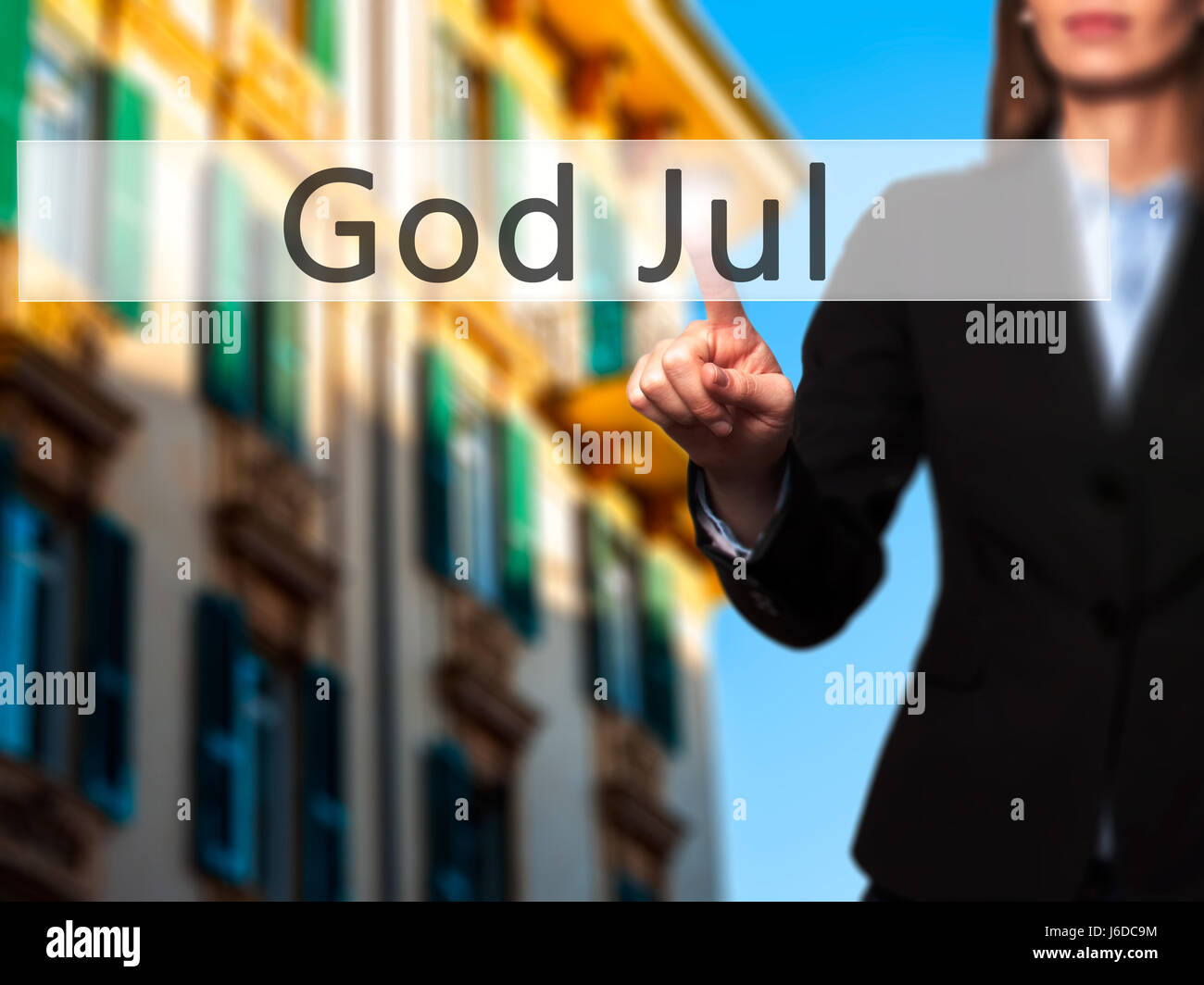 God Jul (Merry Christmas in Swedish) - Businesswoman hand pressing button on touch screen interface. Business, technology, internet concept. Stock Pho Stock Photo