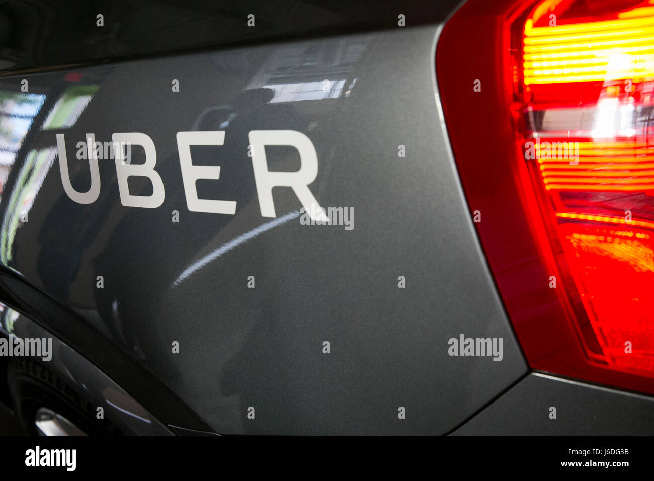 An Uber logo on a Uber Technologies Inc., self-driving autonomous Volvo car. Stock Photo