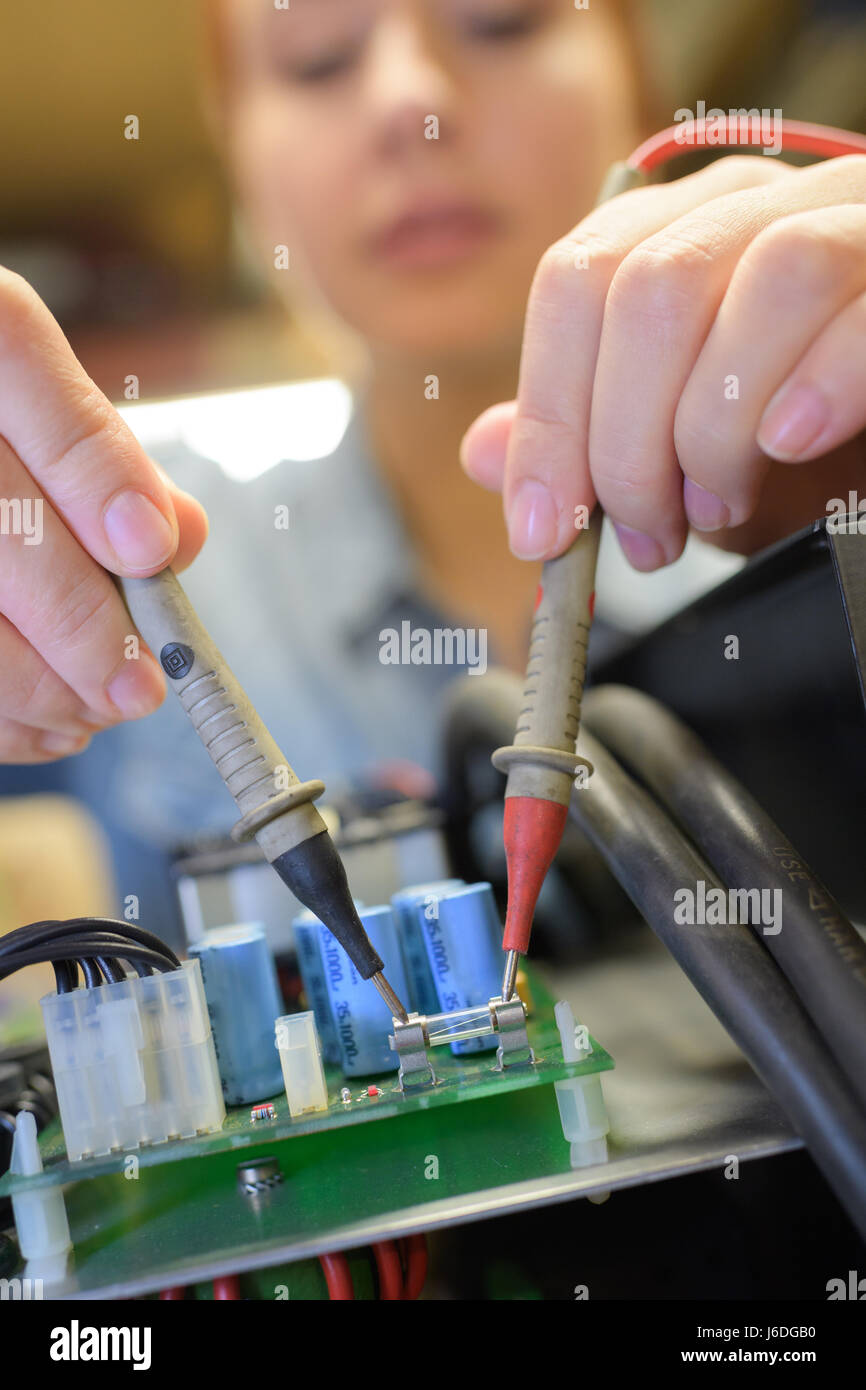 Multimeter probes on circuit board fuse Stock Photo - Alamy