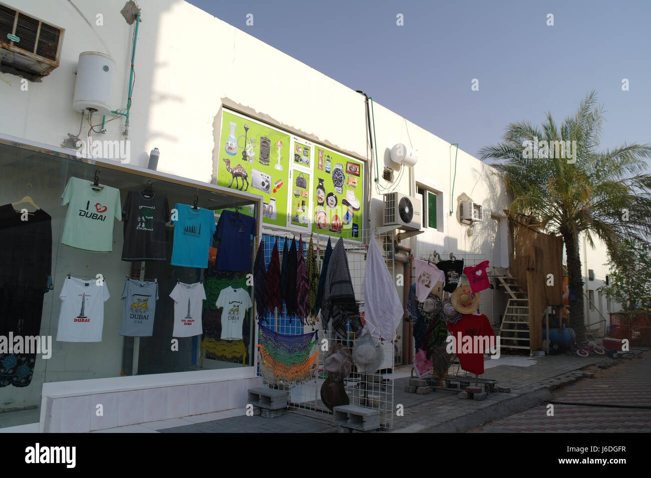 Oblique white building view with shop selling tourist Arab clothes, T-shirts, head-scarfs, hats, Al Badayer, Dubai-Hatta Road, Dubai, UAE Stock Photo
