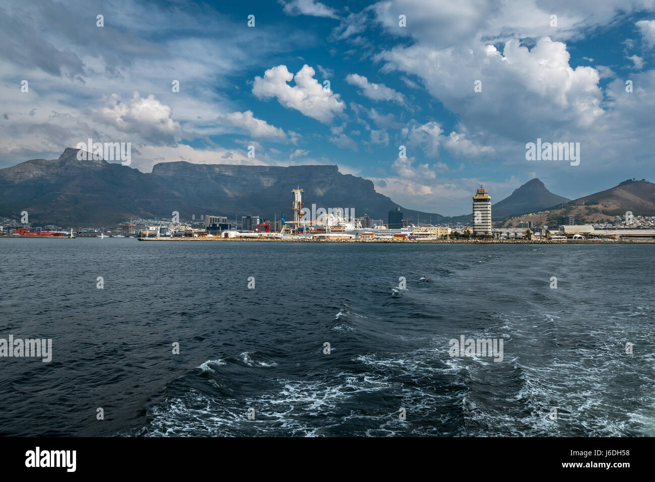 Table Mountain plateau outline seen from the sea with dramatic cloud formations and view of Port Authority tower, Cape Town, South Africa Stock Photo