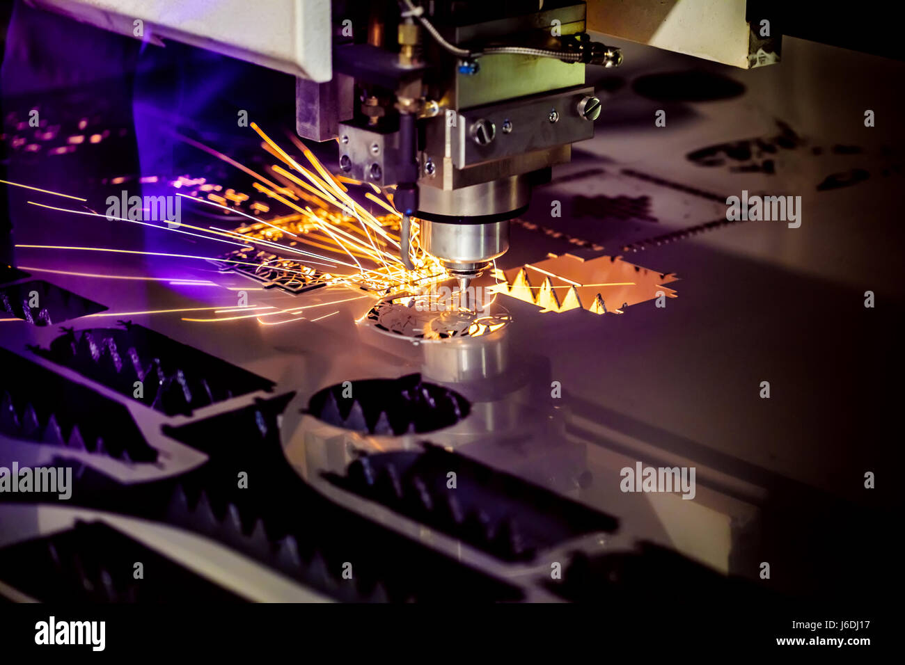 CNC Laser cutting of metal, modern industrial technology. Small depth of field. Warning - authentic shooting in challenging conditions. A little bit g Stock Photo
