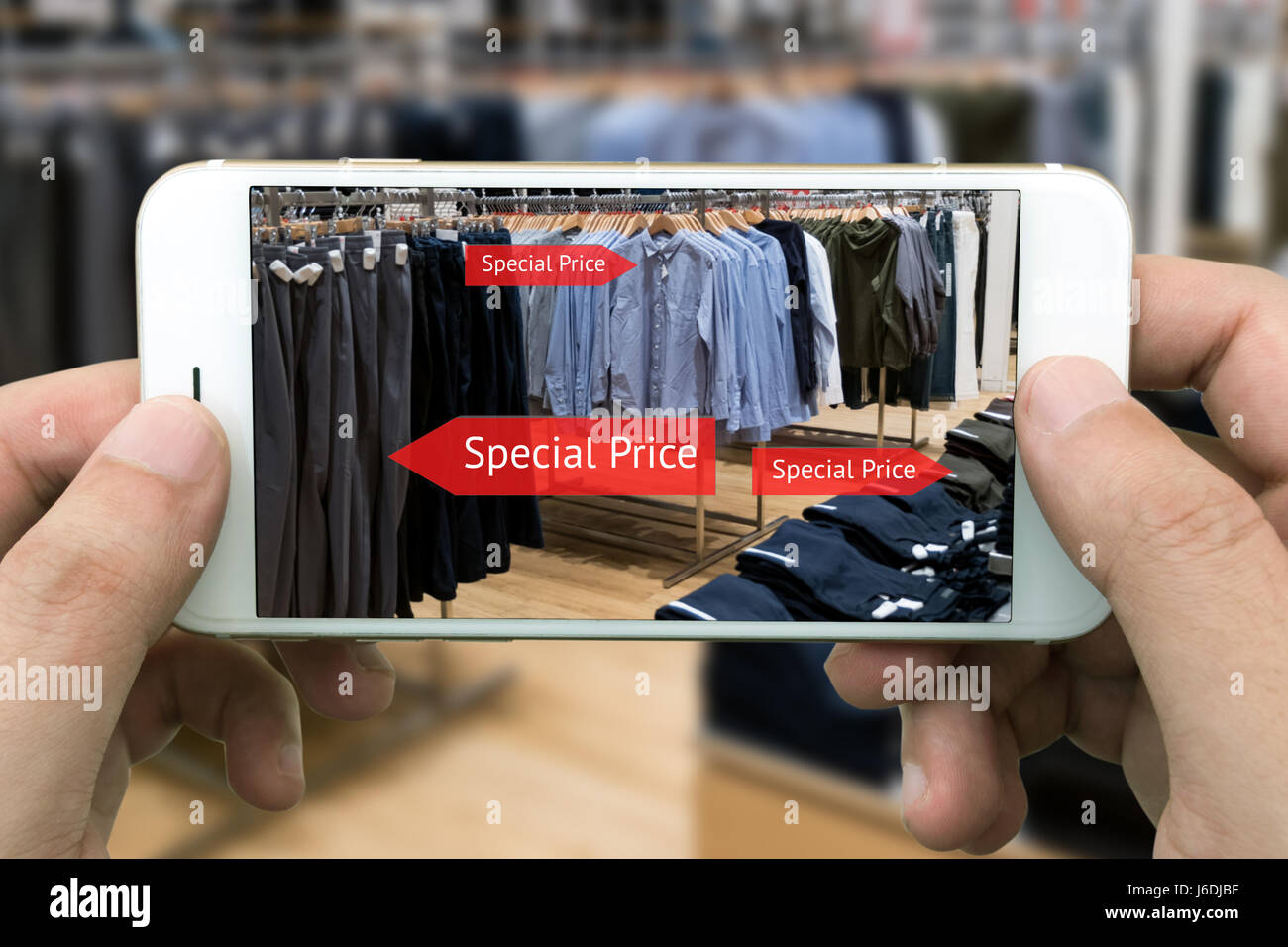 Augmented reality marketing concept. Hand holding smart phone use AR  application to check special sale price in retail fashion shop mall Stock  Photo - Alamy