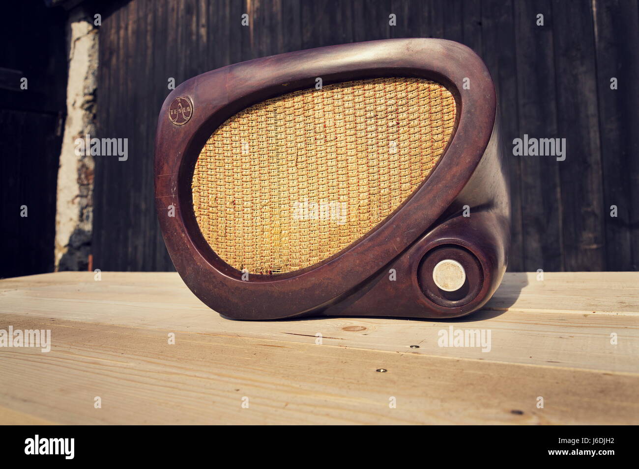 Old brown vintage bakelite Tesla radio on wooden background Stock Photo