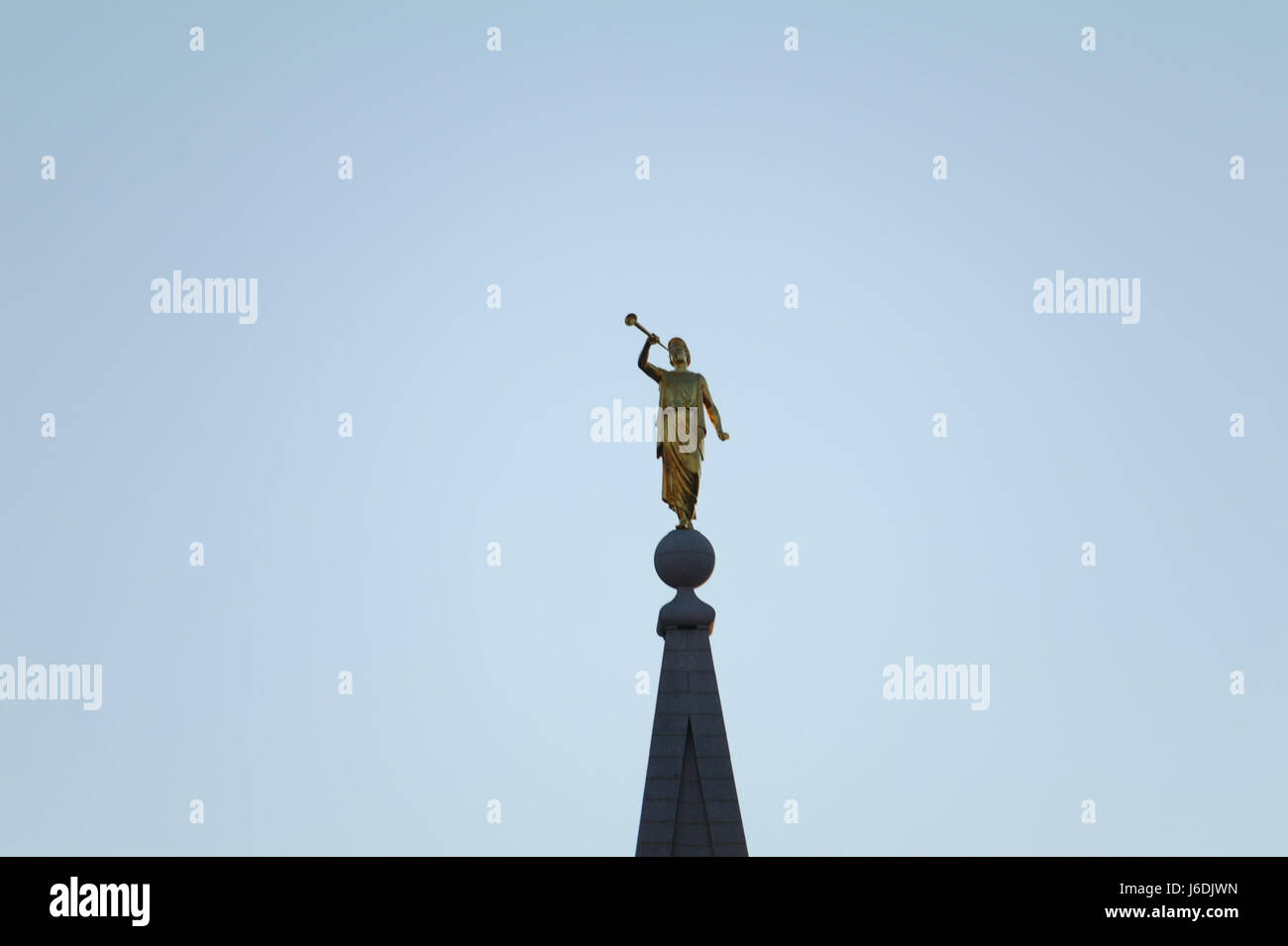 Blue sky twilight view goldplated Angel Moroni Statue top of Central