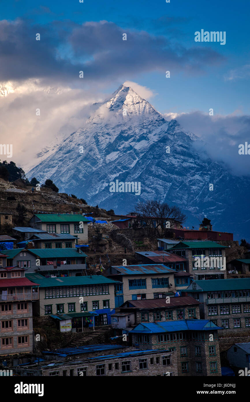 Thamserku (6608 meters) towers behind Namche (3440 meters)  in the background.in the Khumbu Region and Sagarmatha National Park on the way to Mount Ev Stock Photo