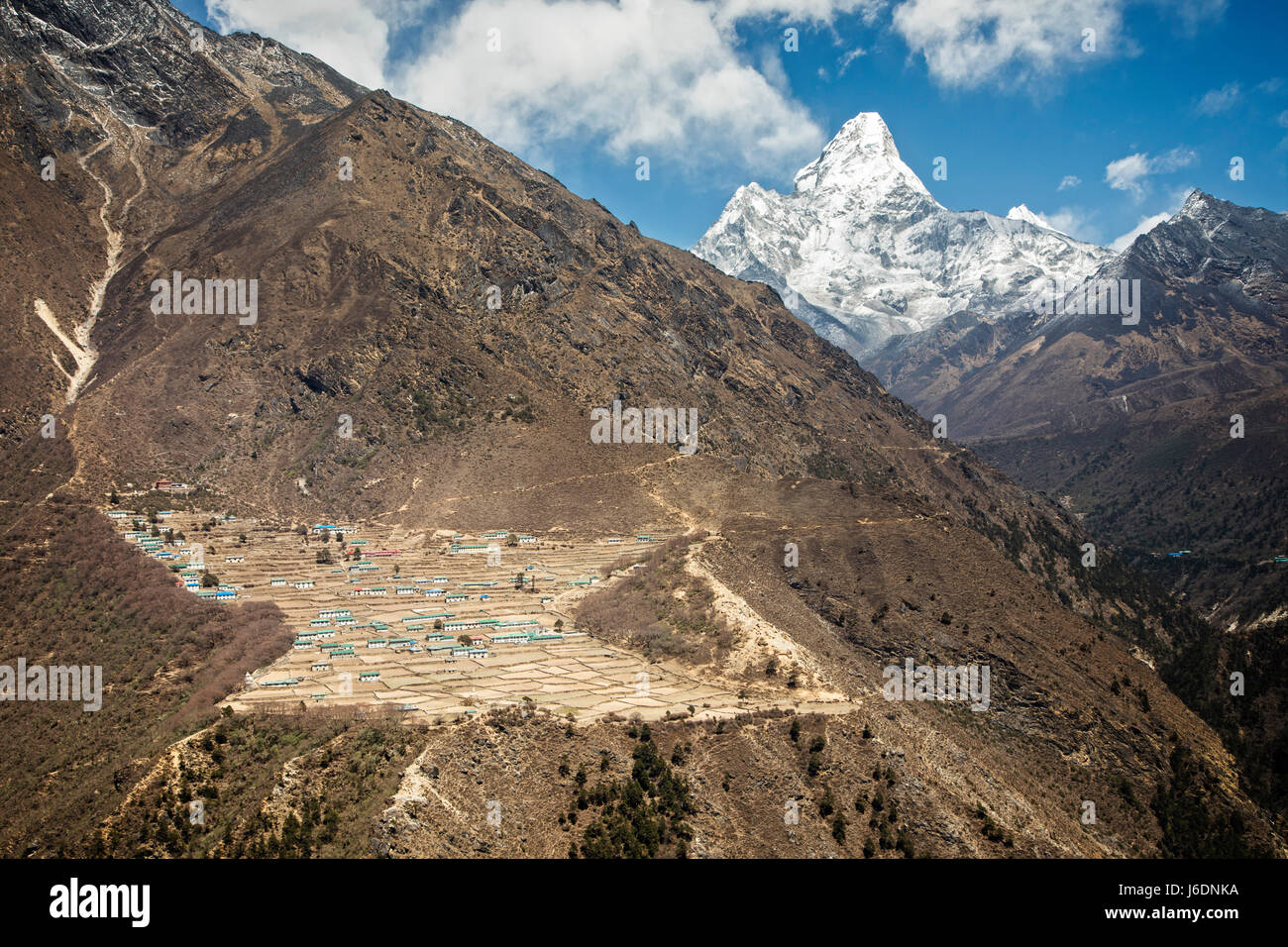 The village of Phortse on a mountainside with Ama Dablam (6856 meters) in the background.  Sagarmatha National Park, Nepal. Stock Photo