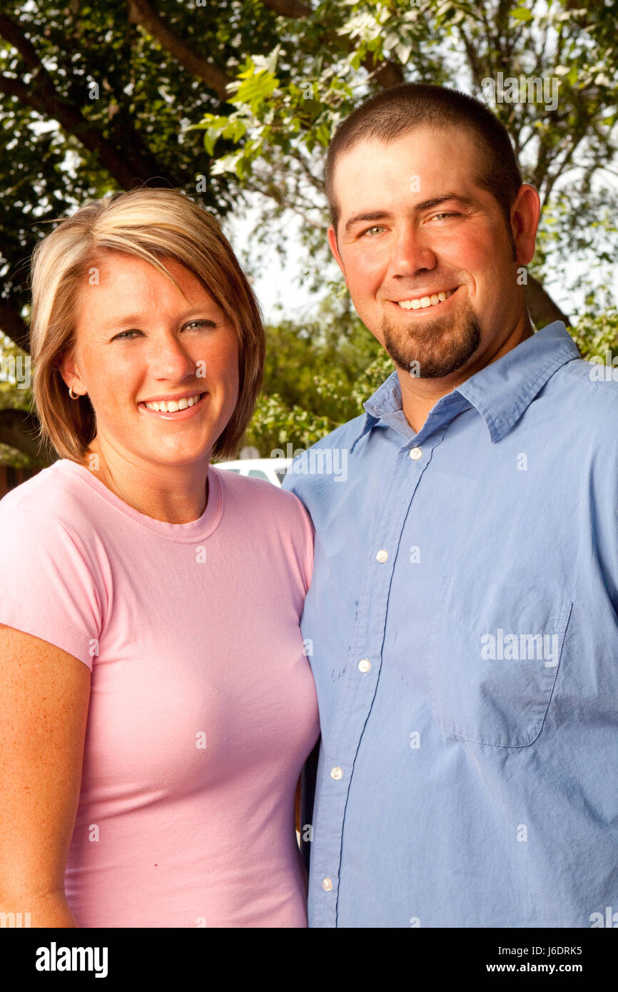 Happy couple smiling and hugging in the park Stock Photo - Alamy