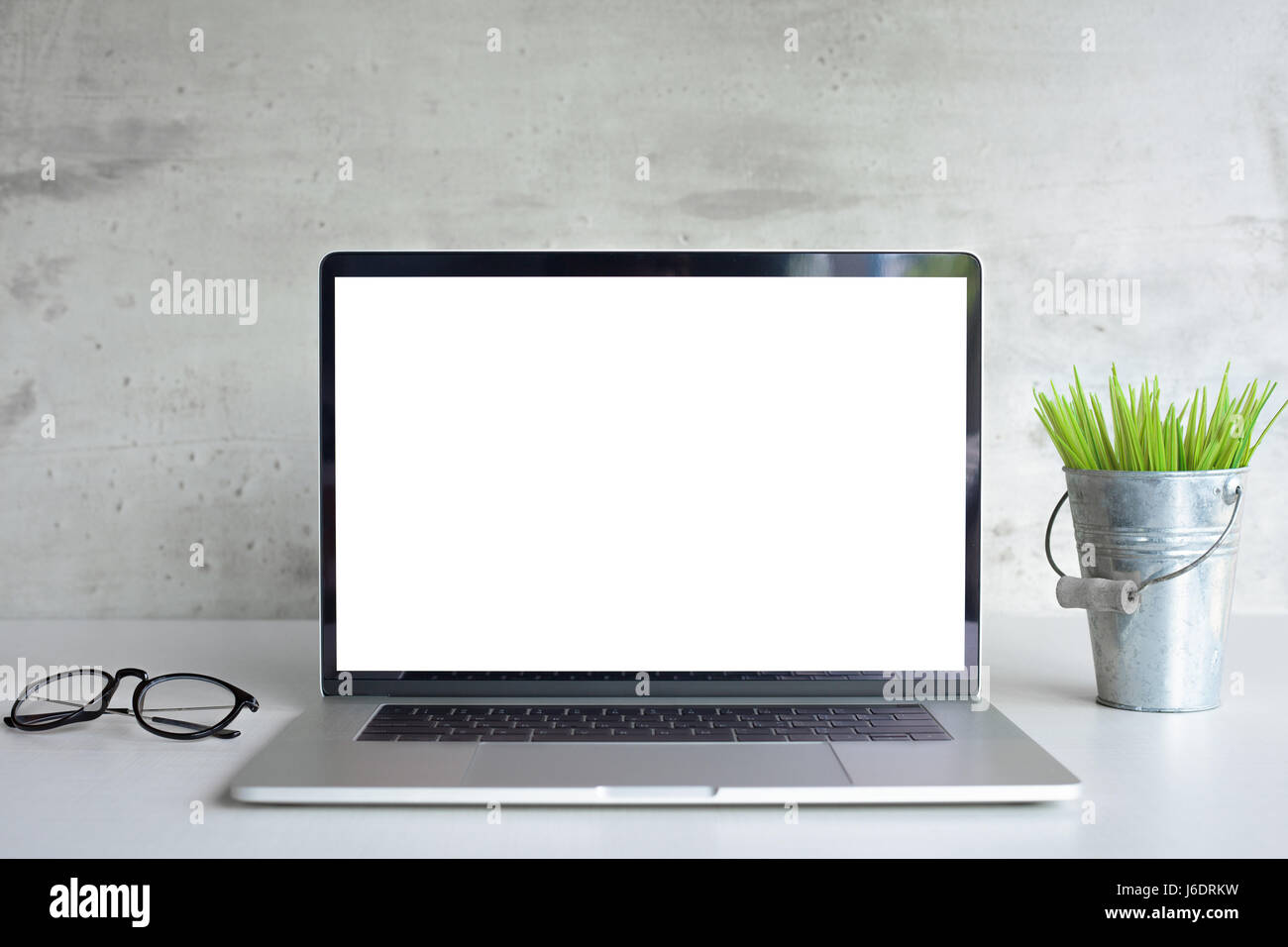 modern laptop computer white screen on desk table front view Stock