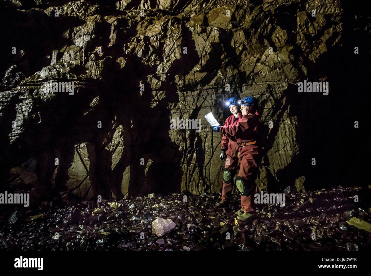 Potholers look at a cave map as they explore Gaping Gill, the largest cavern in Britain, ahead of the site in the Yorkshire Dales National Park being open to the public next weekend. Stock Photo