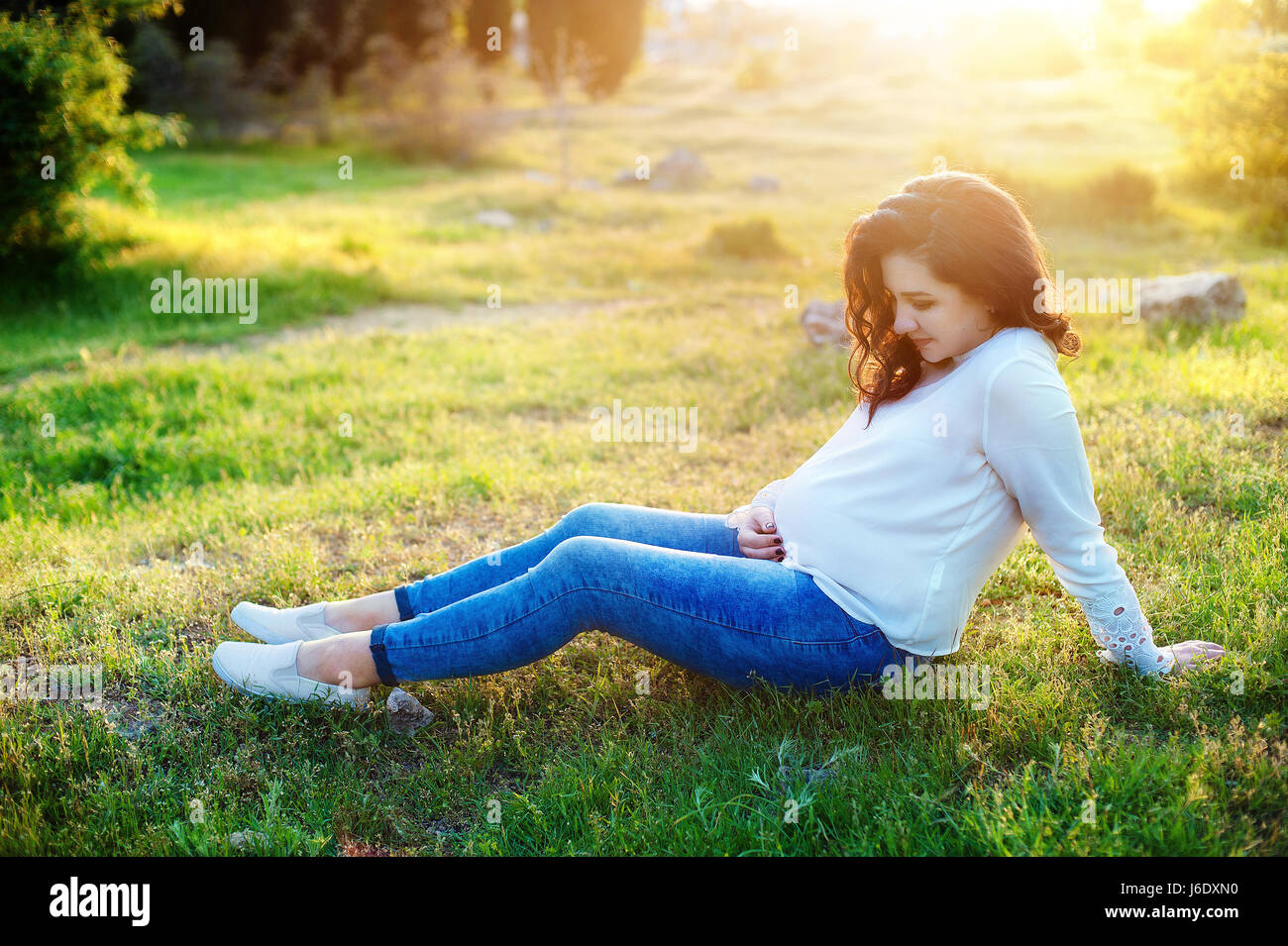 Beautiful pregnant woman relaxing in the park Stock Photo Alamy