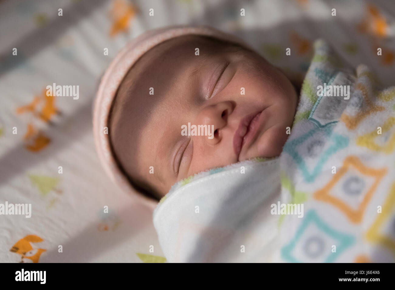 A 4 week year old baby in her crib Stock Photo