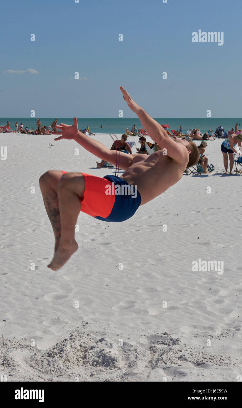 student somersaulting on Siesta Beach, Florida Stock Photo